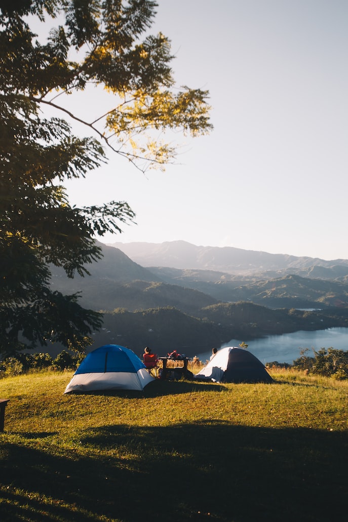 People Resting in the Mountains with Tents